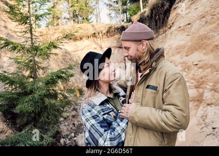 Young affectionate couple looking at each other and enjoying the nature outdoors Stock Photo