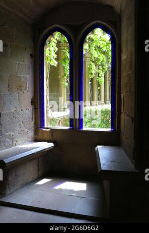 Looking out through arched windows with stone benches at Moreras courtyard in the 13th century Palace of the Kings of Navarre of Olite Spain Stock Photo