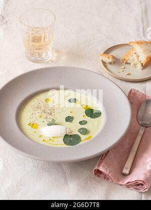 From above asparagus mascarpone cream soup near napkin and beverage on table Stock Photo