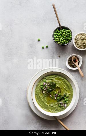 From above, delicious peas cream over concrete white table Stock Photo