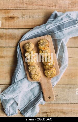 Top view of cutting board with delicious sweet potato falafel placed on cloth napkin on lumber table Stock Photo