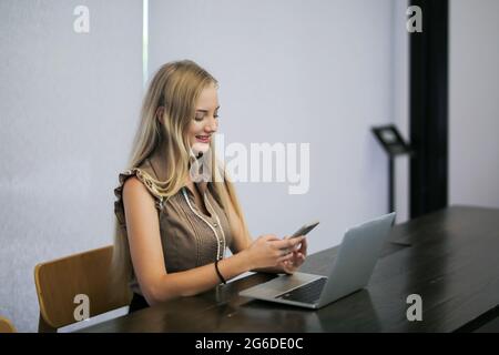 Beauitul young woman working using computer laptop concentrated and smiling Stock Photo