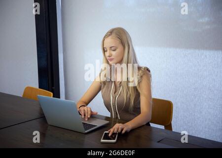 Beauitul young woman working using computer laptop concentrated and smiling Stock Photo