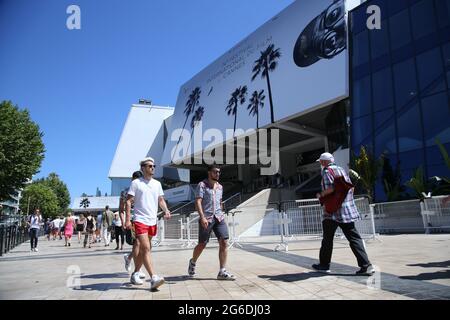 Cannes, France. 05th July, 2021. Visitors walk in front of the Palais des Festivals the day before the start of the 74th annual Cannes International Film Festival in Cannes, France on Monday, July 5, 2021. Photo by David Silpa/UPI Credit: UPI/Alamy Live News Stock Photo