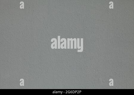 Gray wall, texture, background. The building wall, painted with water-based paint. Smooth (flat) surface in gray color. Gray (grey) plane Stock Photo