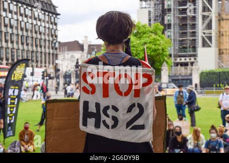 London, UK. 05th July, 2021. A demonstrator carries a 'Stop HS2 (High Speed 2 railway system)' banner during the Kill the Bill protest. Demonstrators gathered in Parliament Square in protest against the Police, Crime, Sentencing and Courts Bill, which many say would give police more powers over protests in the UK. Credit: SOPA Images Limited/Alamy Live News Stock Photo