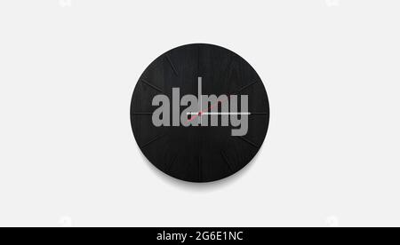 Stylish black round clock on a white wall. Time on the wall as an element of the interior. Simple modern round clock on white wall Stock Photo