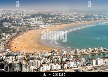 White modern architecture surrounding amazingly wide sandy beach in Agadir, Morocco, North Africa Stock Photo