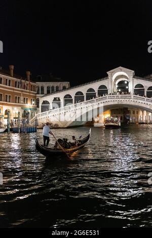 Venetian gondola on Grand Canal, Rialto Bridge at night, dawn, Venice, Veneto, Italy Stock Photo