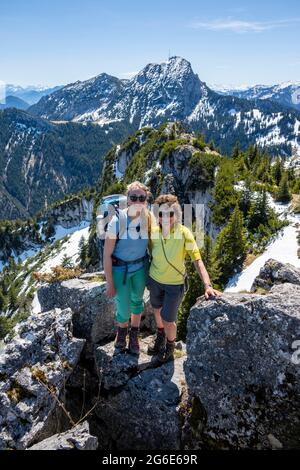 Two female hikers on the summit of Breitenstein, behind Wendelstein, Fischbachau, Bavaria, Germany Stock Photo