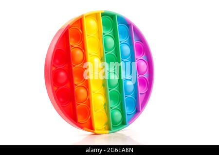 Popit toy for children relaxation and entertainment. Multicolor rainbow round isolated on the white background Stock Photo