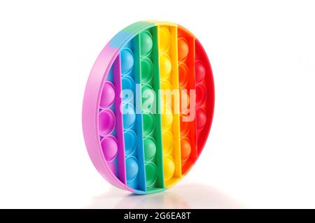 Popit toy for children relaxation and entertainment. Multicolor rainbow round isolated on the white background Stock Photo