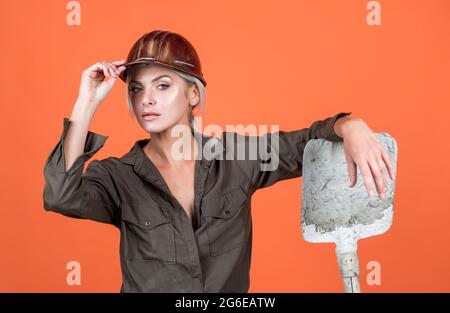 a bit tired. building and construction. lady architect worker. engineer on orange background Stock Photo