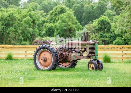 Old rusted tractor in the rain Stock Photo