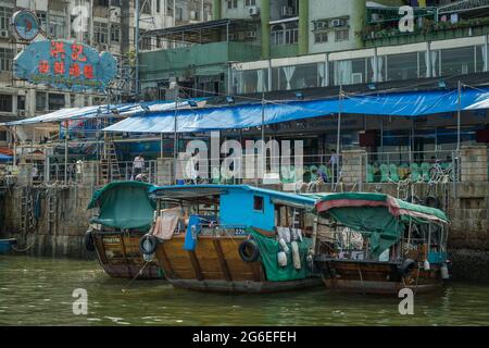 Junks used to ferry tourists to the islands of Port Shelter moored at the Sai Kung waterfront, New Territories, Hong Kong Stock Photo