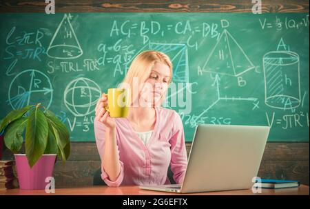 Female teacher at her desk marking students work. Pretty teacher ...