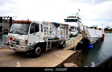 Heavily laden truck with flamable cargo leaving roll on Roll off vehicle ferry at Arcadia on Magnetic Island in north Queensland Australia Stock Photo