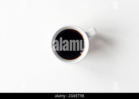 Ceramic mug with hot black coffee, top view as flat lay, space for text Stock Photo