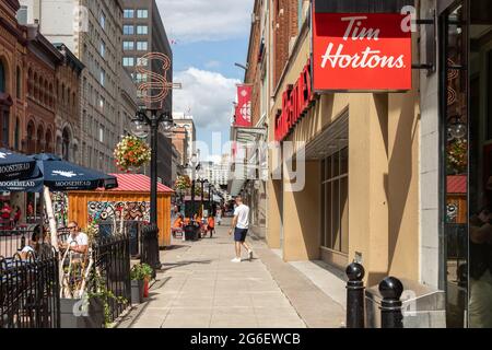 Ottawa, Canada - July 1, 2021: Cityscape street view with walking people in downtown of Ottawa. Sparks street during Canada day holiday. Stock Photo