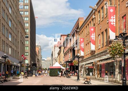 Ottawa, Canada - July 1, 2021: Cityscape street view with walking people in downtown of Ottawa. Sparks street during Canada day holiday. Stock Photo