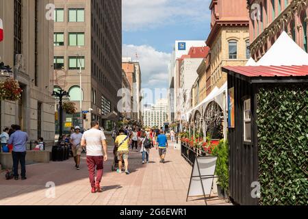 Ottawa, Canada - July 1, 2021: Cityscape street view with walking people in downtown of Ottawa. Sparks street during Canada day holiday. Stock Photo