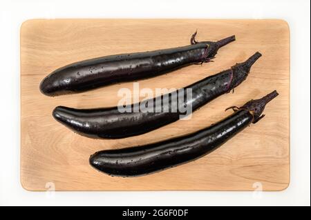 eggplant or aubergine vegetable on cutting board Stock Photo