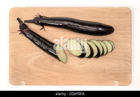 eggplant or aubergine vegetable on cutting board Stock Photo