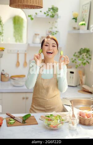 Funny young housewife cooking in kitchen Stock Photo - Alamy