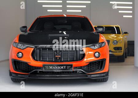 Kiev, Ukraine - November 17, 2017: Mansory Maserati Levante  on the background of Bentley Bentayga Mansory. Two luxury SUVs in bright colors in the ga Stock Photo