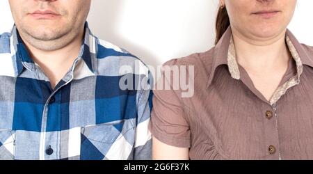 Overweight man and woman with double chin on their face, close-up. Family obesity concept Stock Photo