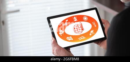 Global warming concept shown on a tablet held by a man Stock Photo