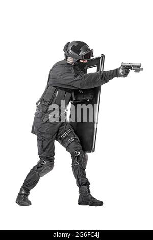 Studio shot of SWAT police special forces hiding behind ballistic