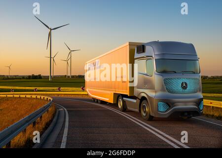 Mercedes electric truck with semitrailer with DHL logo Stock Photo