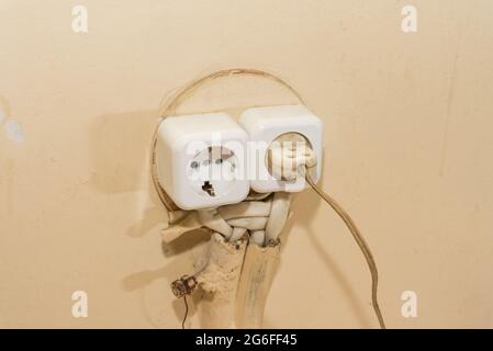 New socket, old plug electrical wiring in the house. Stock Photo