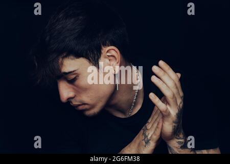 Young man with tattoos clapping the hands Stock Photo