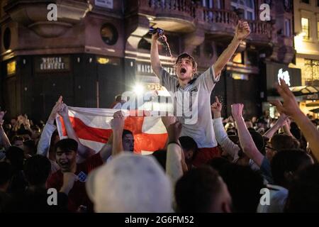 English football fans celebrate in Leicester Square after the Euro 2020 England versus Ukraine match, London, 3 July 2021 Stock Photo