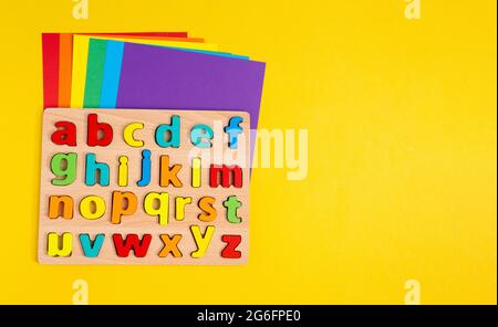 Learning letters, website, video blog. Yellow background Copy space Stock Photo
