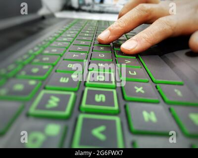 Typing on the keyboard. Using the keyboard. The hand on the keyboard. Computer and keyboard. Stock Photo