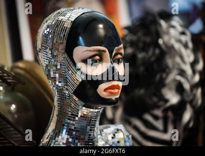 Strange sparkling mannequin head with mirrored glass pieces wearing fashion mask in headshot. Mysterious and beautiful with bright lipstick vibrant Stock Photo