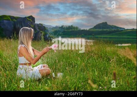 Blonde girl practicing meditation at dawn Stock Photo