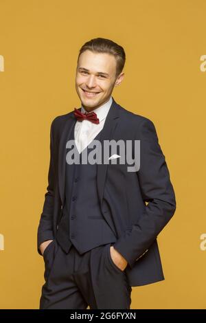 Portrait handsome young man in three piece suit Stock Photo