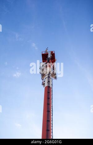 Technology on the top of the telecommunication GSM 5G,4G,3G tower.Cellular phone antennas on a building roof.Telecommunication mast television antenna Stock Photo