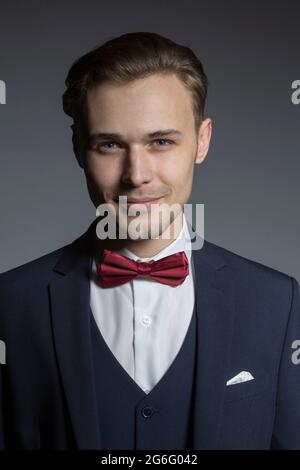 Portrait handsome young man in three piece suit with bow tie Stock Photo