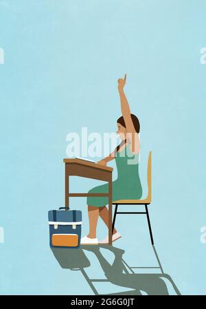 Schoolgirl raising hand at classroom desk Stock Photo - Alamy