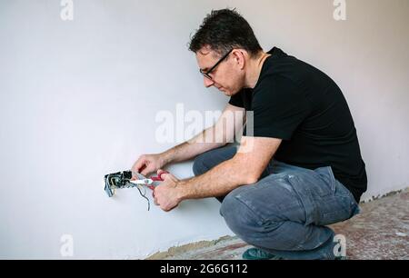 Electrician working on the electrical installation of a house Stock Photo