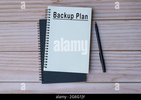Backup plan text on notepad with wooden background Stock Photo