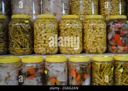 Pickle bottles. Cucumbers, peppers and sauerkraut. Stock Photo