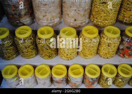 Pickle bottles. Cucumbers, peppers and sauerkraut. Stock Photo