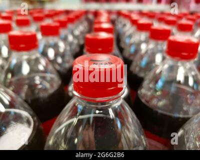 Drinks at the grocery store. Red cap drinks. Sequential drinks on the shelf. Stock Photo