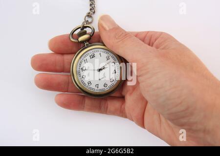 hand with open-face pocket watch Stock Photo